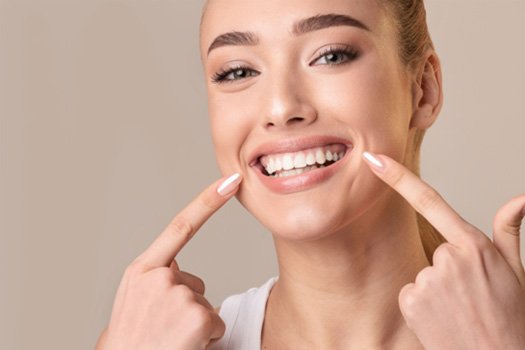 Lighten teeth discolored by root canal treatment near River Edge